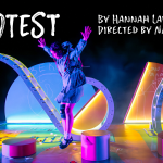 Protest: Stage lit with colourful play equipment. 3 girls jump around.