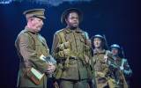 Gareth Radcliffe (Sergeant Thunder) and Ike Bennett (David Taylor) and ensemble in War Horse. c. Brinkhoff-Moegenburg